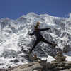 Hiker jumping in front of the Salkantay glacier