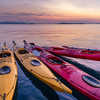 Komodo,Indonesia, colorful Kayaks bound together on the ocean at sunset