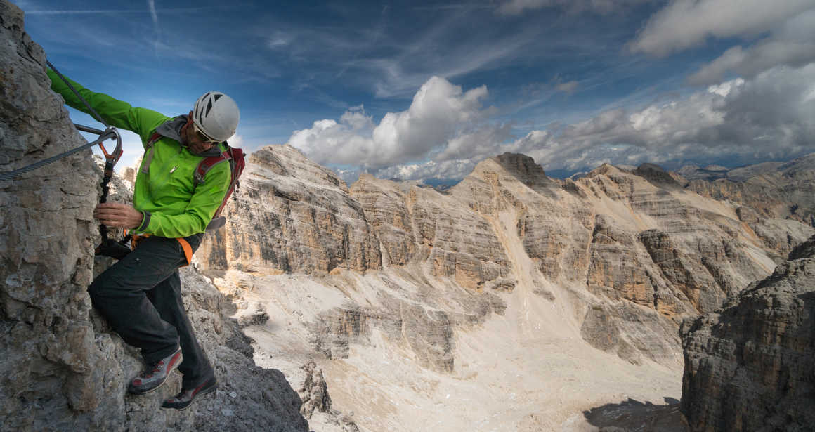 Climber using via ferrata in Italy