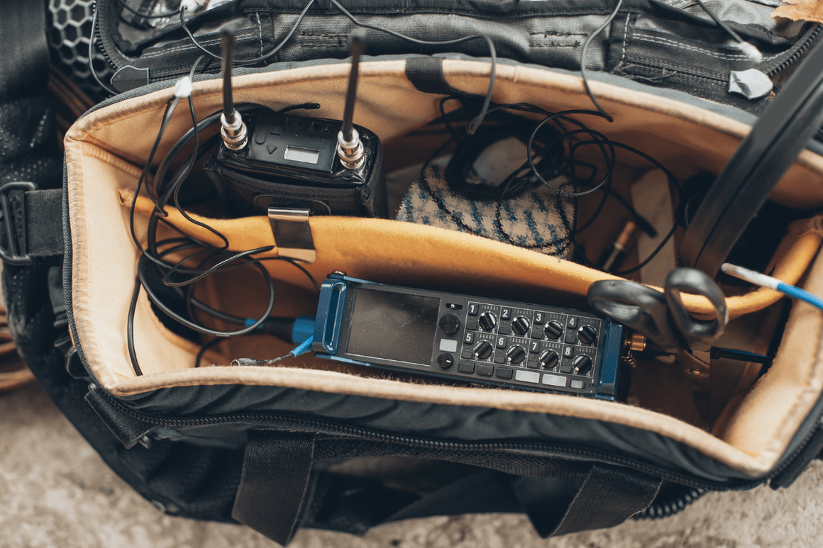 Close up of trekkers bag filled with filming equipment