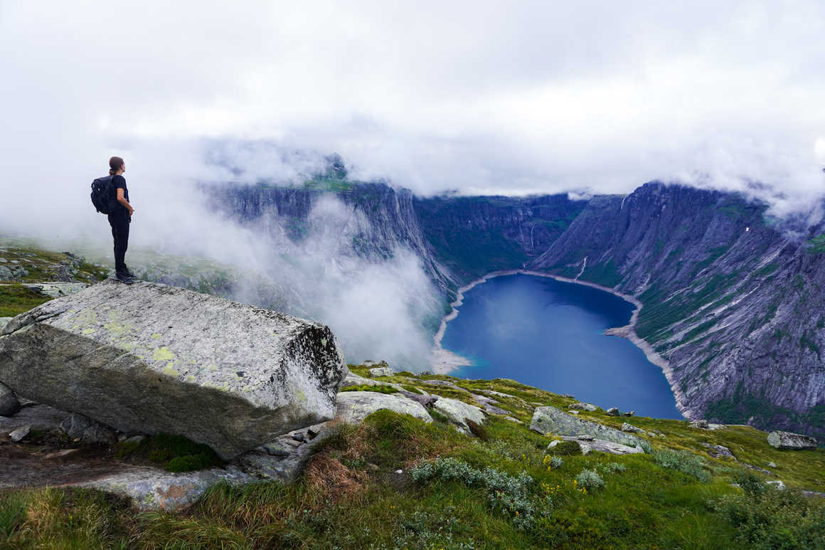 Hiker looks over Ringedalsvatnet Lake on the Trolltunga hike