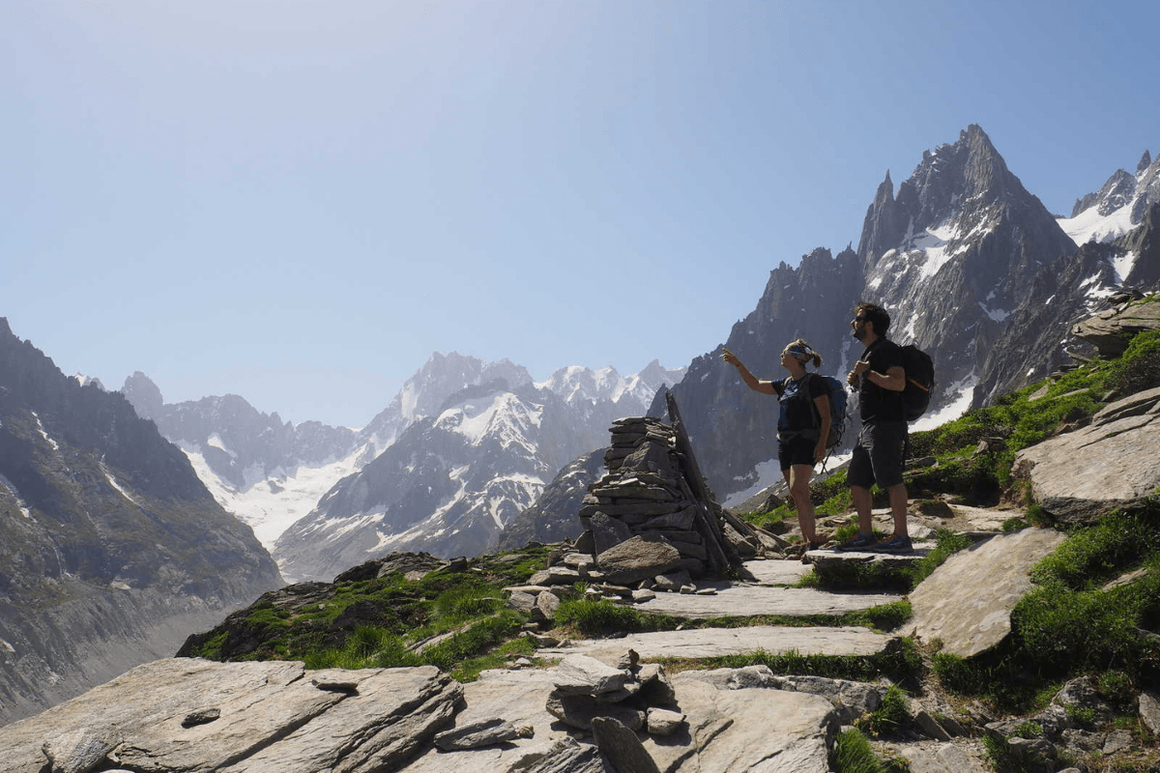 Male and Female trekkers admiring mountain surroundings