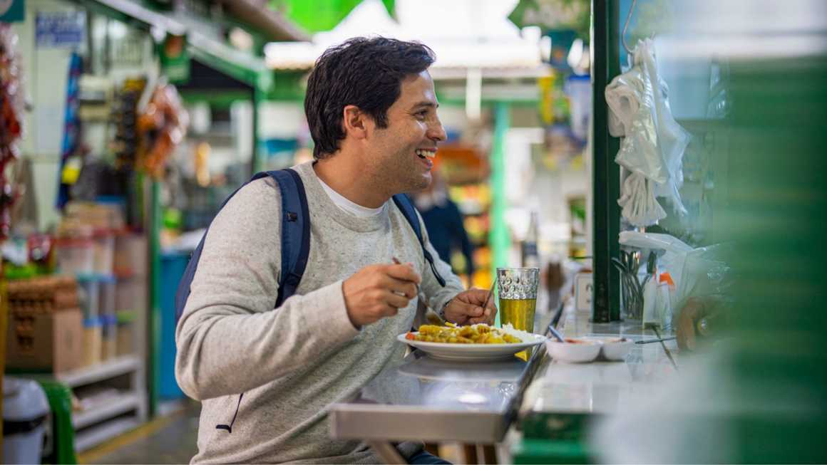 Man enjoying peruvian food at a street market