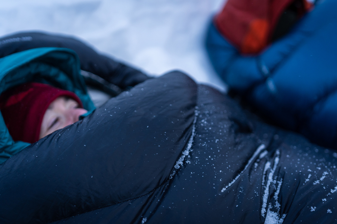 Man in sleeping bag in snow