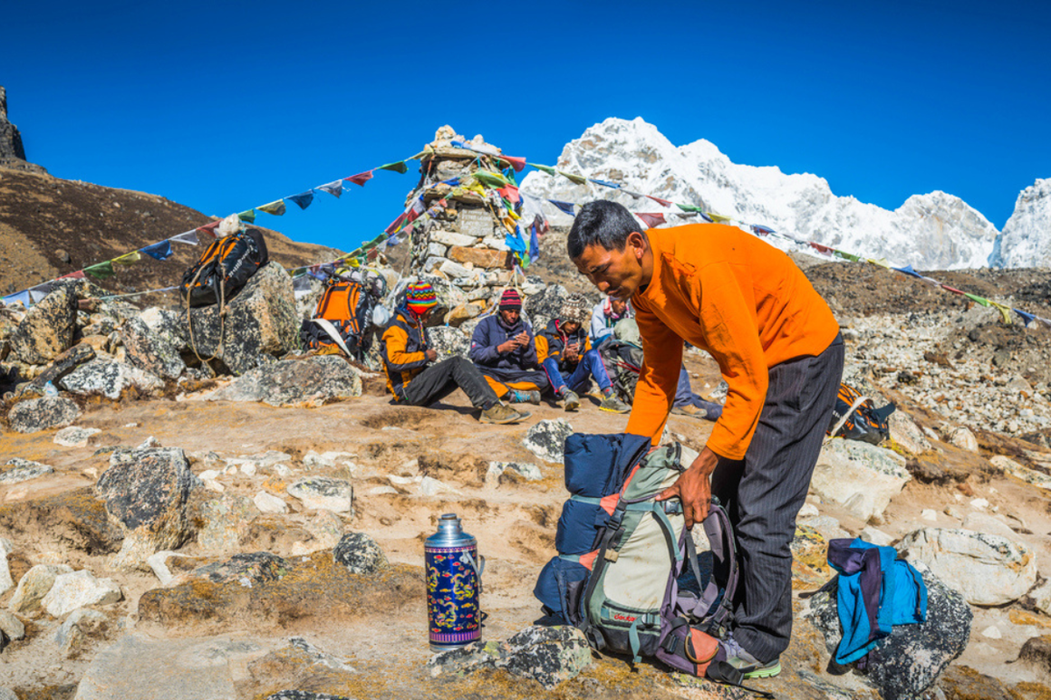 Sherpa guide packing daypack at Everest base camp