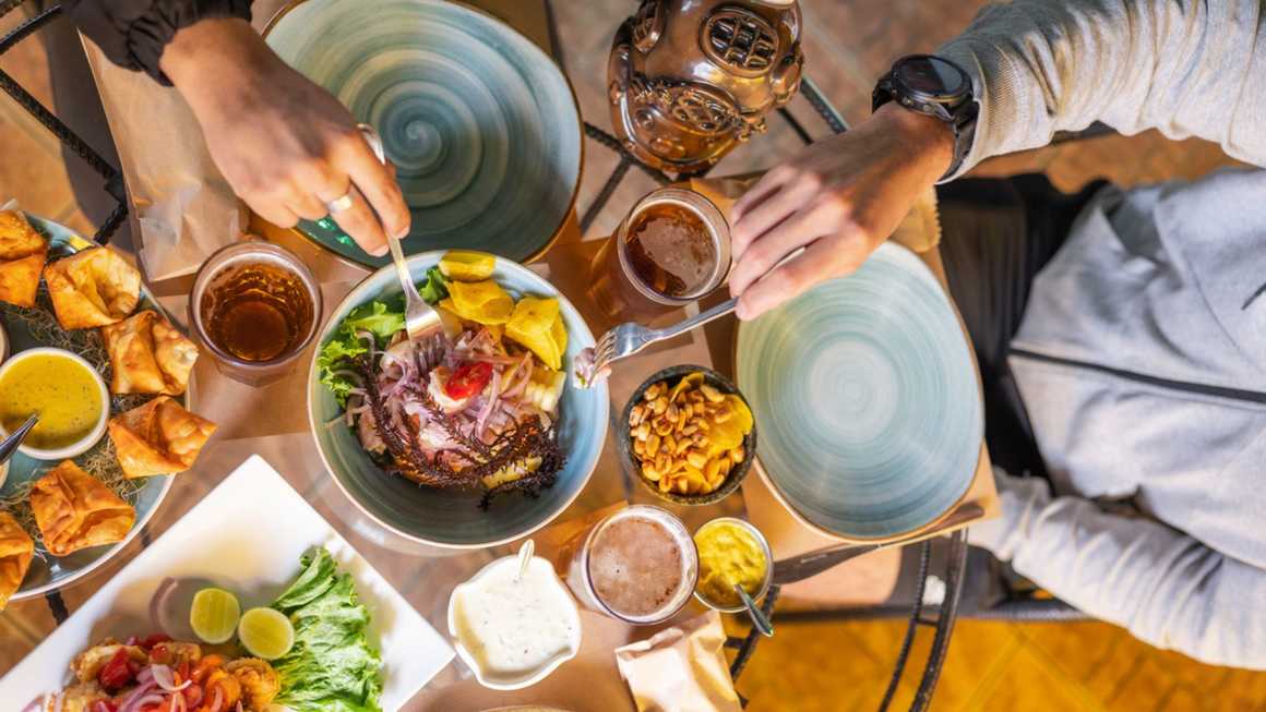 Table of people eating Peruvian food