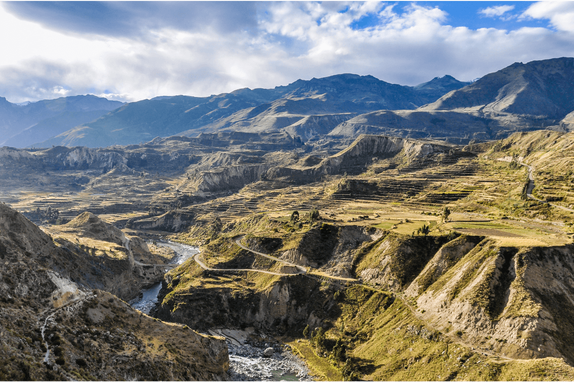 Terraced mountain valley with paths and rivers zig zagging the slopes