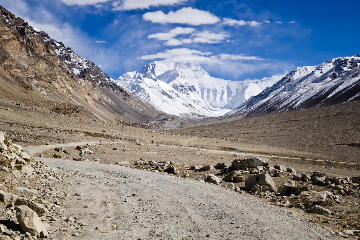 The road to Mount Everest base camp in Tibet with the imposing north face of Mount Everest towering in the background