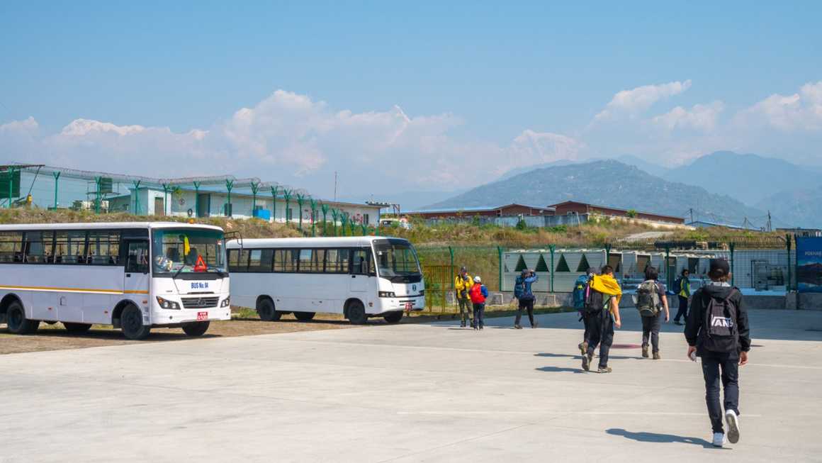 Tourist walking to the main terminal after plane landing in Pokhara international airport