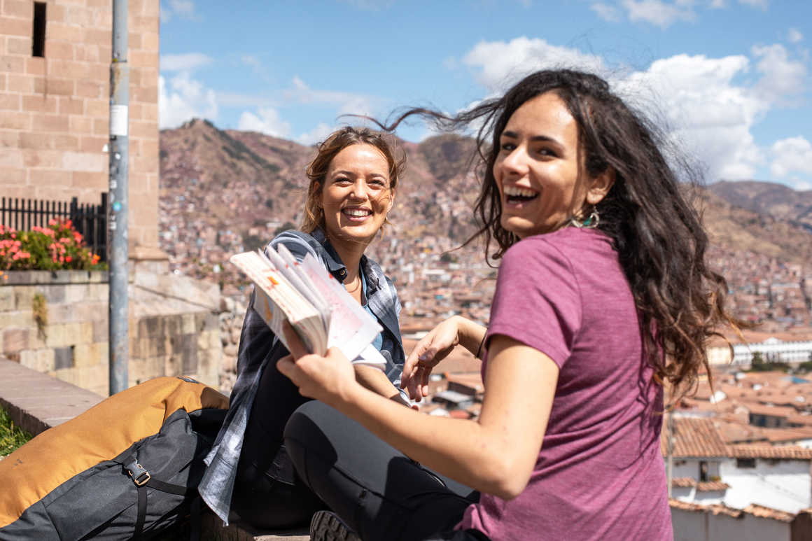 Travellers reading a guide in Cusco