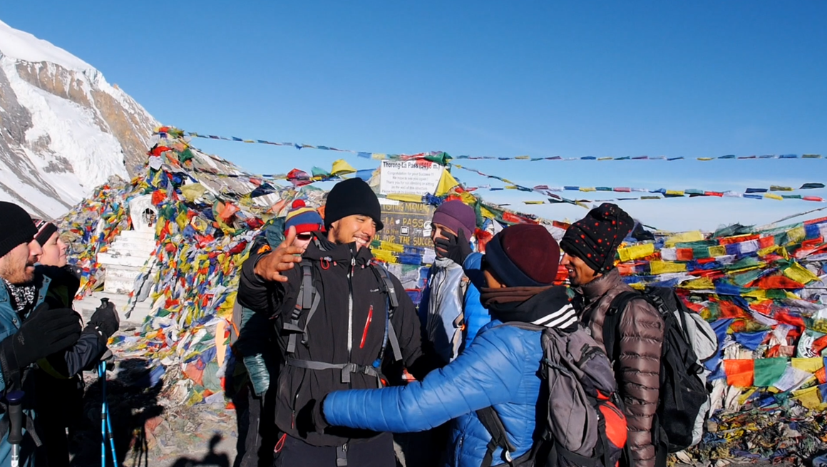 Trekker's hug when reaching a summit on the Annapurnas Circuit