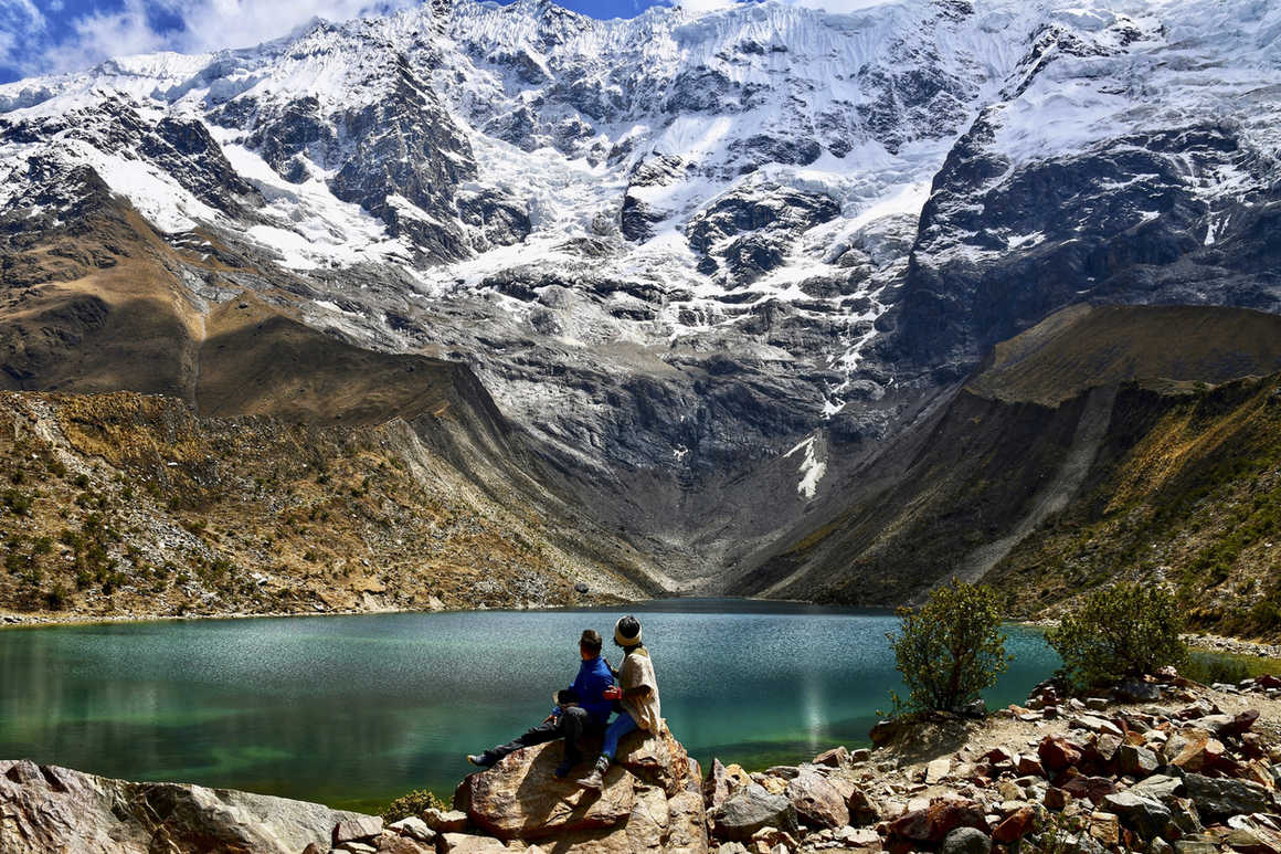 Trekkers look over Lake Humantay, Peru