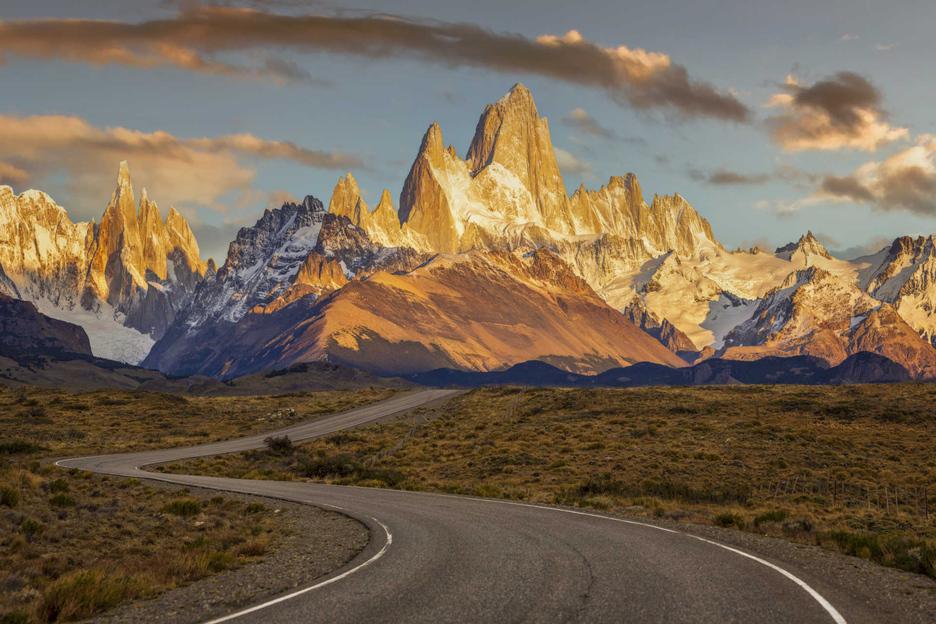 A windy road leads to Mt. Fitz Roy, surrounding mountains and the town of El Chalten