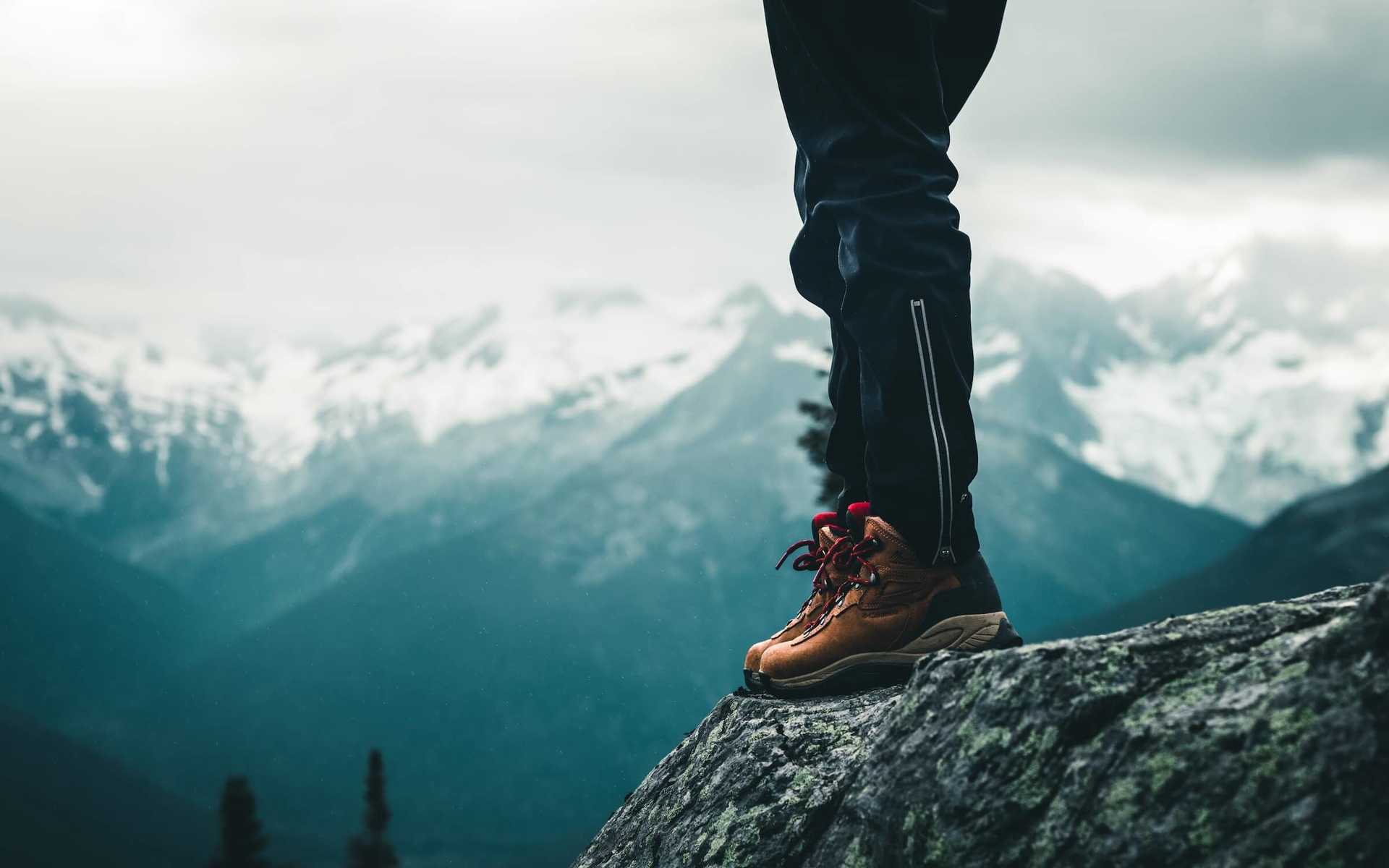 Hiker in hiking boots and socks in the mountains