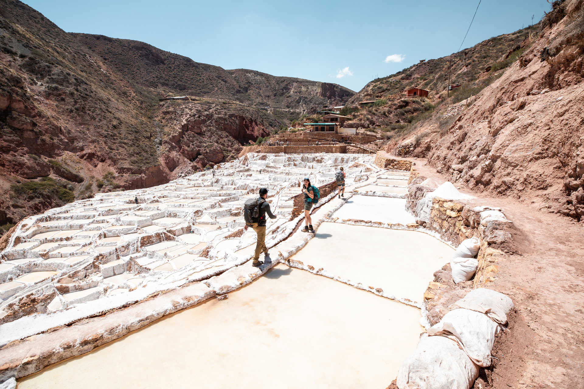 Hikers walking in the Salineras de Maras, region of Cusco