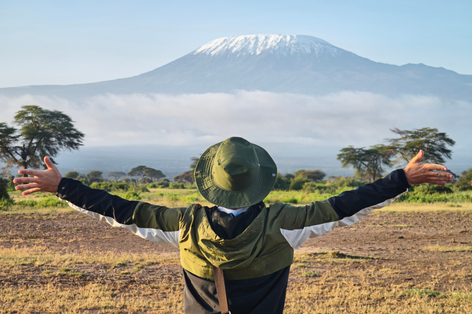 Man looking at Kilimanjaro with open arms