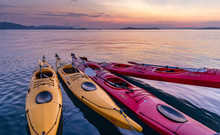 Komodo,Indonesia, colorful Kayaks bound together on the ocean at sunset