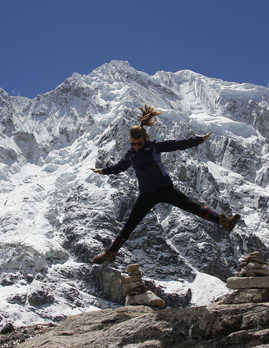 Hiker jumping in front of the Salkantay glacier