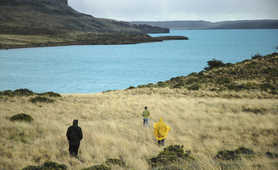 Hikers getting closer to a beautiful lake in Patagonia
