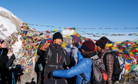 Trekker's hug when reaching a summit on the Annapurnas Circuit