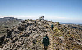 Two trekkers on the summit of Mount Elgon in Uganda