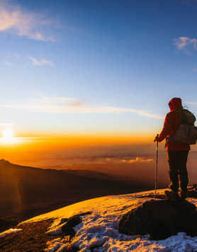 Hiker on Kilimanjaro summit for sunrise