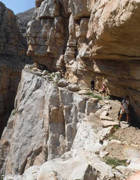 Hikers walking in the impressive cliffs of Musandam