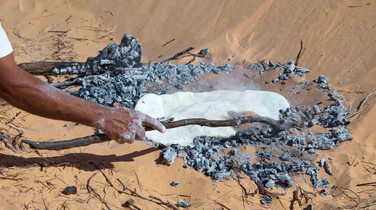Baking bread in the desert sands of the Sahara