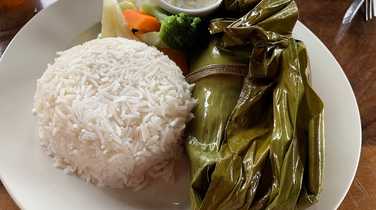 Local fish cooked in banana leaf - traditional dish in Uganda