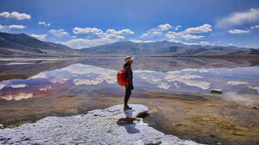 Trekker enjoying the view of Tso Kar Lake, Ladakh, India
