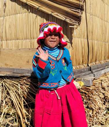 girl-in-traditional-dress-at-the-islands-of-uros