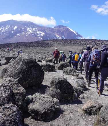 Group of hikers on rocky slopes of Kilimanjaro