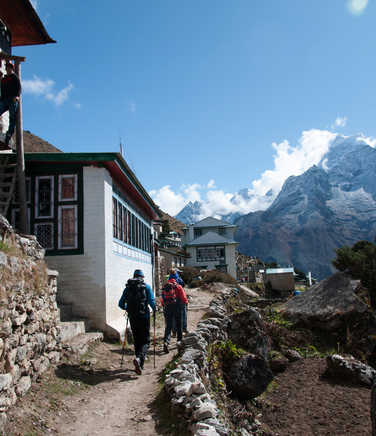 Hikers crossing a village in the Everest region