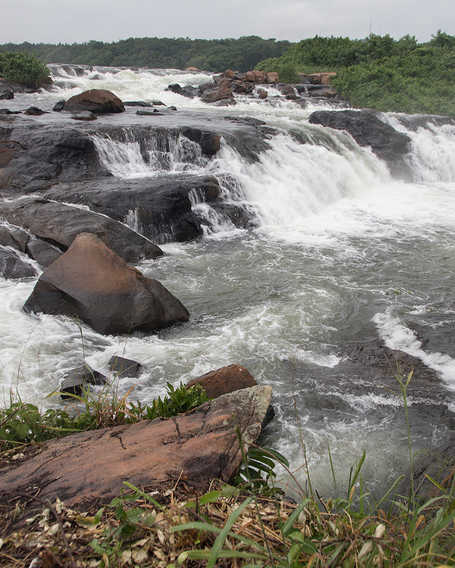 Water falls across rocks in the River Nile in Uganda