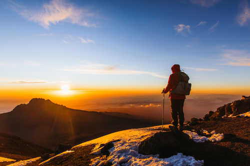 Hiker on Kilimanjaro summit for sunrise