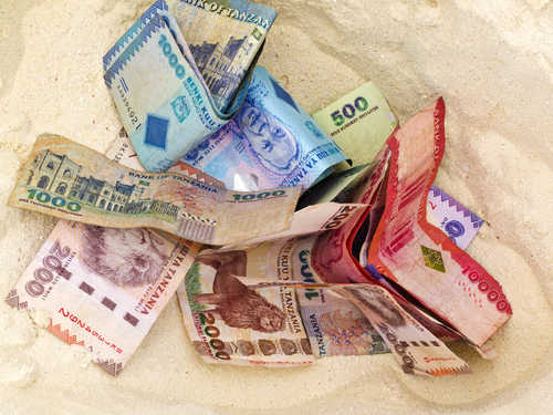 Tanzanian currency in the sand