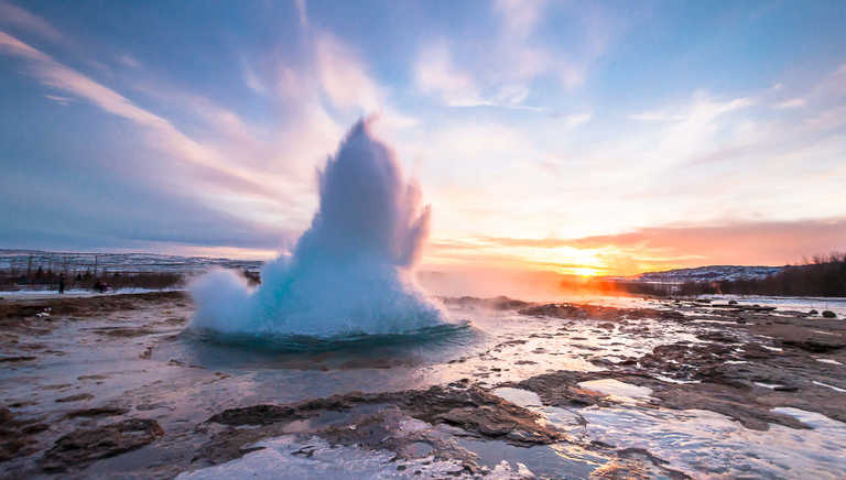 Geysir-erupting-from-the-icy-pool-below