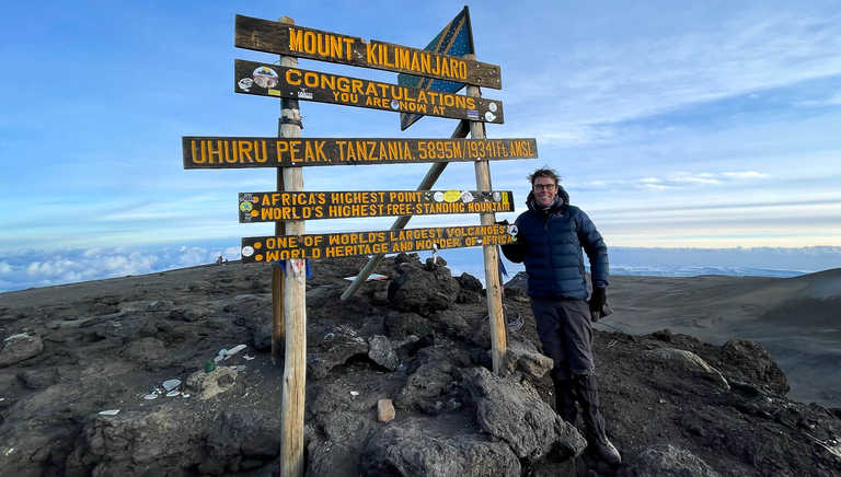 Staff member Dan at the summit of Kilimanjaro