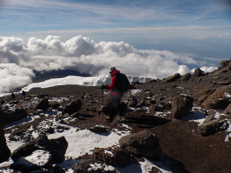 Hiker at the summit of Kilimanjaro