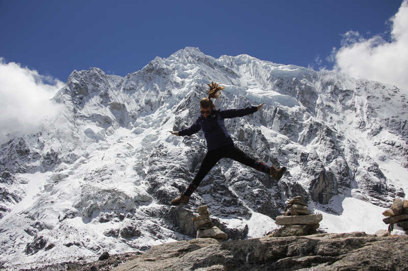 Hiker jumping in front of the Salkantay glacier