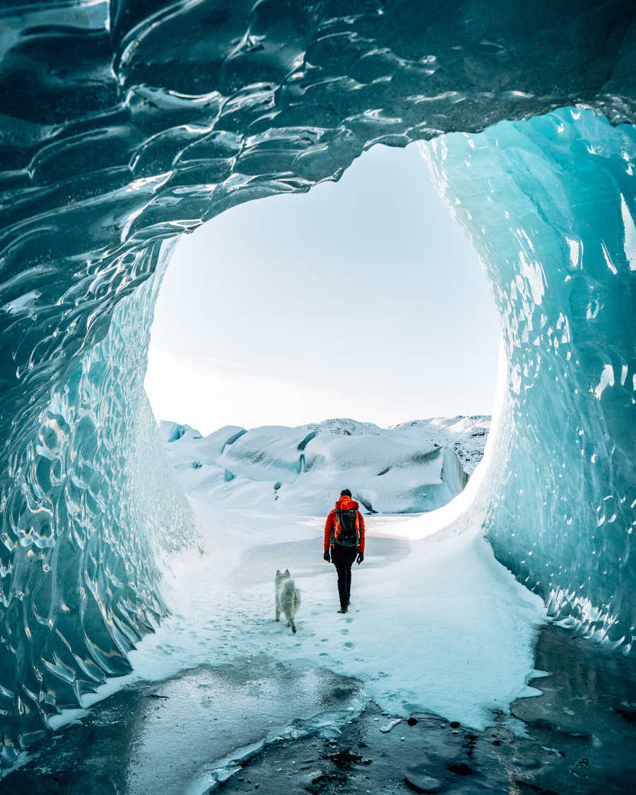 Hiker in a ice cave in Iceland
